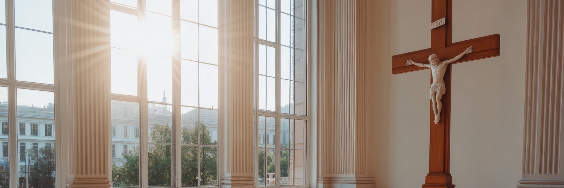 Sunlight streaming through tall windows illuminates a crucifix